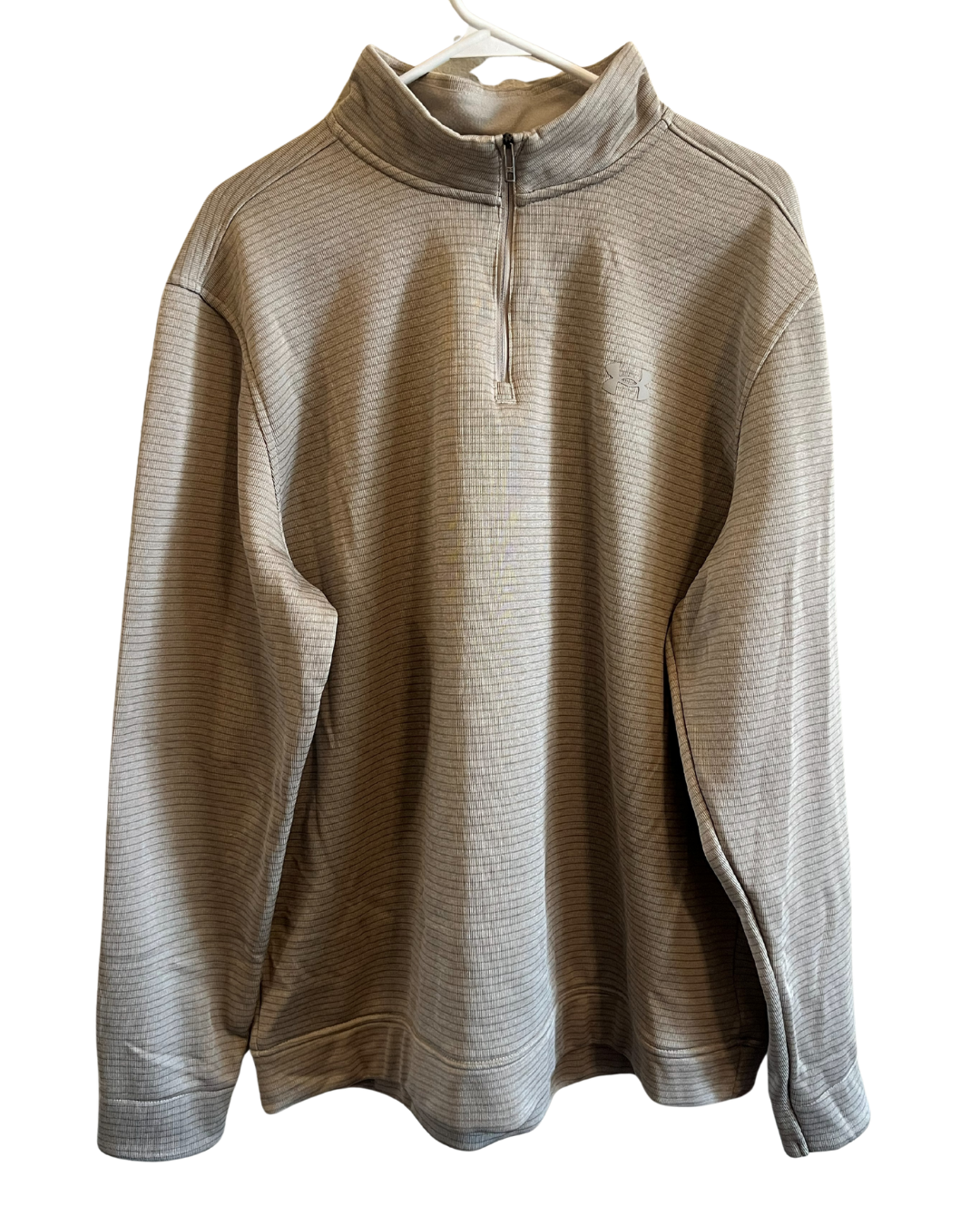 A long-sleeve quarter-zip pullover sweatshirt in a textured, heathered taupe-beige fabric, hanging on a white plastic hanger against a plain white background.